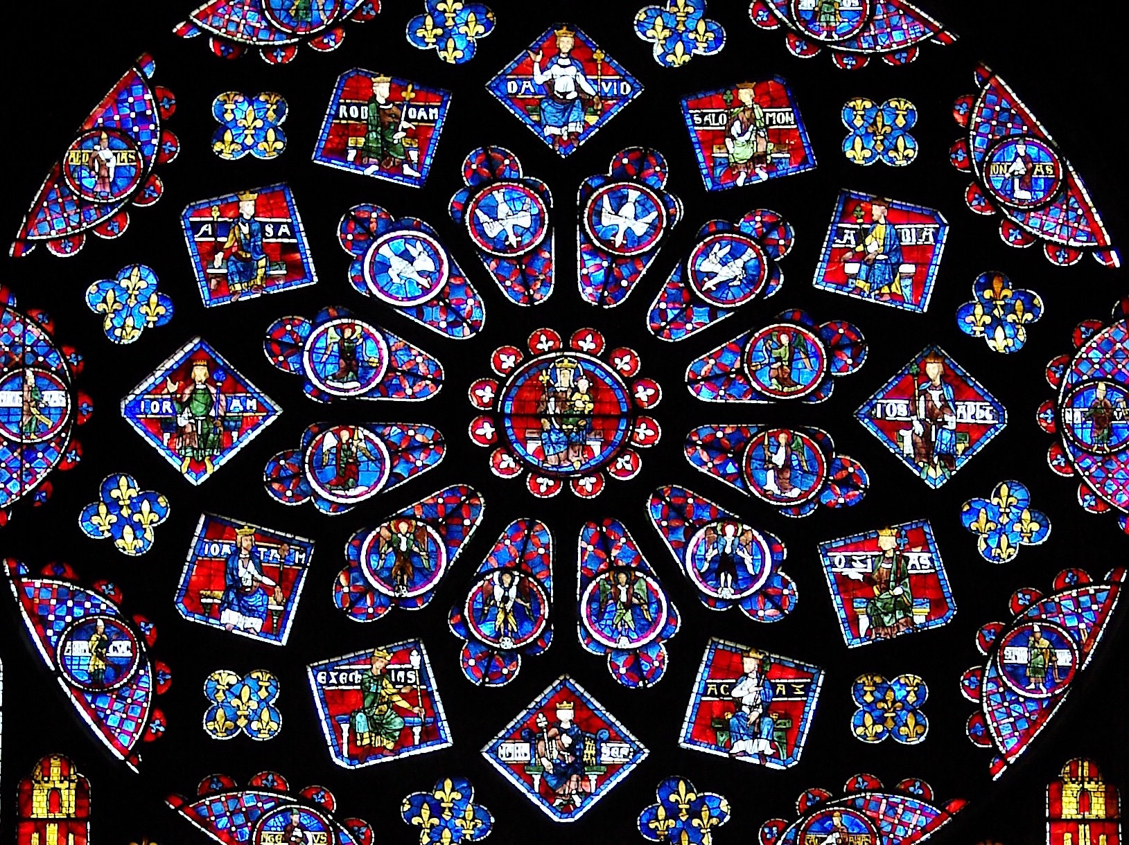 Photograph of a stained glass window with vivid red and blue tones.